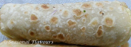 Roll up the paratha with stuffing for Kolkata Roll Recipe