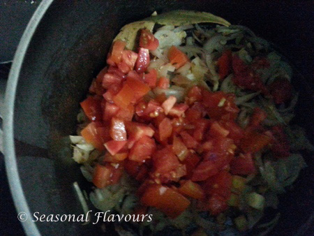 Add tomatoes for yellow peas curry