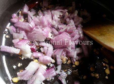 Add onions, garlic to Aratikaya Fry tempering
