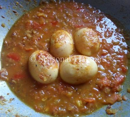Add fried eggs for spicy anda gravy Andhra style