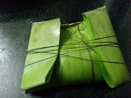 Tie up fish wrapped in banana leaf parcel