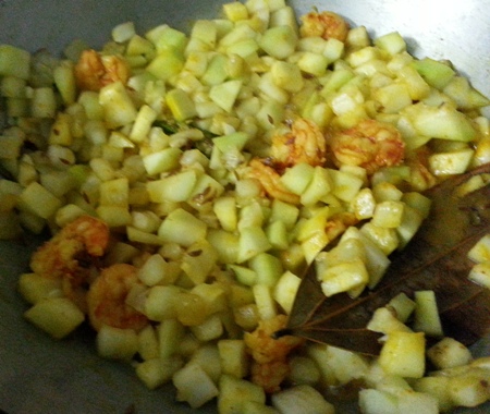 Add spices to bottle gourd with prawns curry