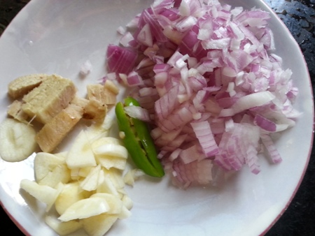 Chopped onions, ginger and garlic for spinach potato curry