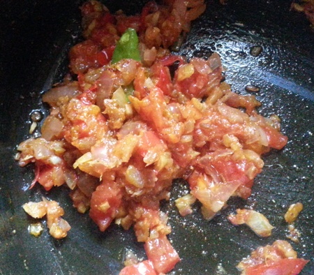 Add chopped tomatoes and spices for potato with spinach