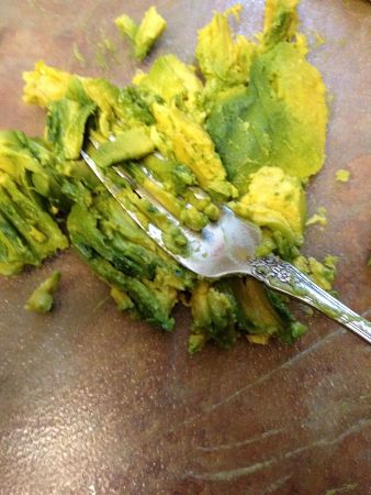 Mash the avocado flesh for Mexican spread recipe