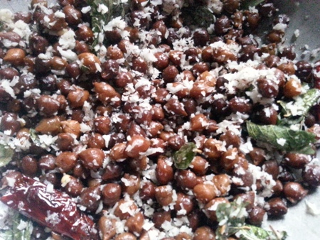 Add freshly grated coconut to brown chickpeas