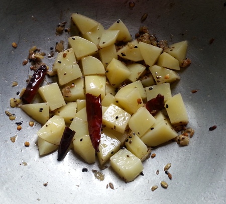 Fry potatoes with spices for alu kumro chakka