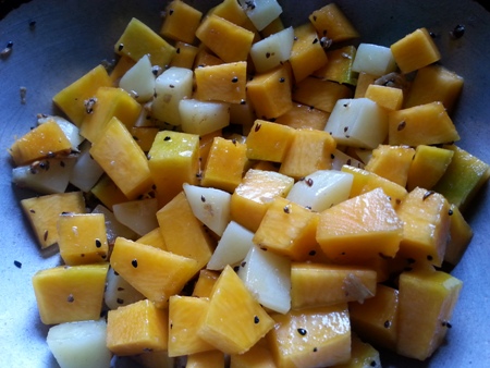 Add cubed pumpkin and black chickpeas for kumror chokka tarkari