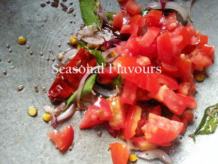 Chopped tomatoes and hing for spiced tomato rice