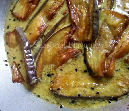 Add fried eggplant slices to gravy