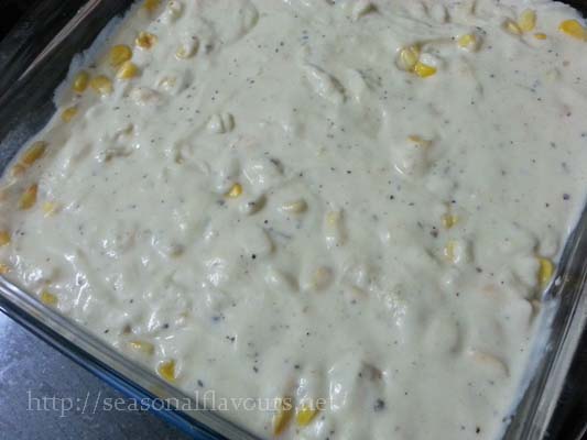 Top creamed maize with cheese and seasoning