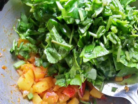 Add Spinach to sauteed potatoes for aloo palak sabji recipe