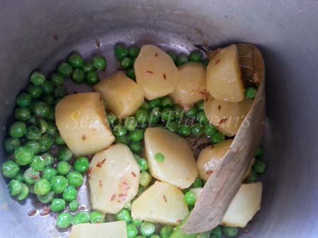 Add aloo and peas for khichdi in cooker recipe