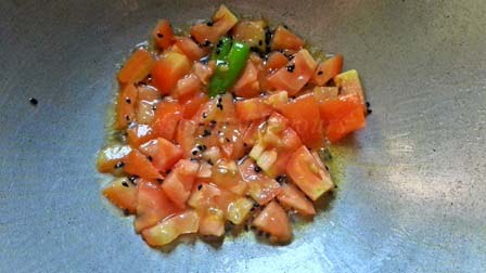 chopped tomato for Shorshe Bhetki fish curry Bengali style recipe