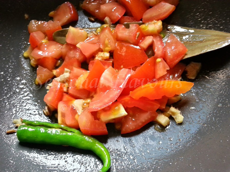 Add tomatoes for lauki vadi sabzi