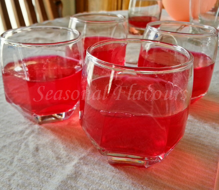 Pour raspberry jelly into glasses