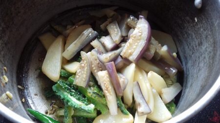 Add sauteed vegetables for Bengali curry