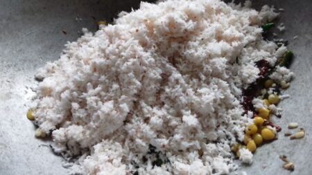 Add grated coconut for Coconut Rice preparation