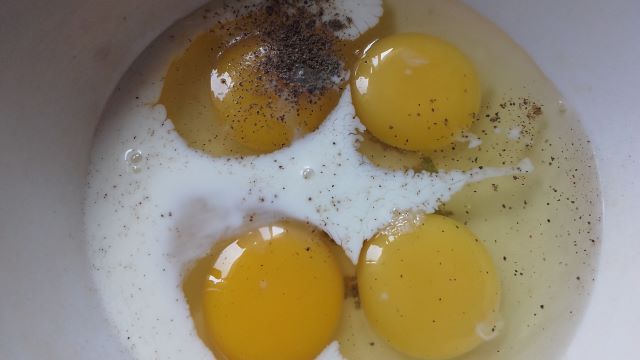 Add milk and spices to eggs