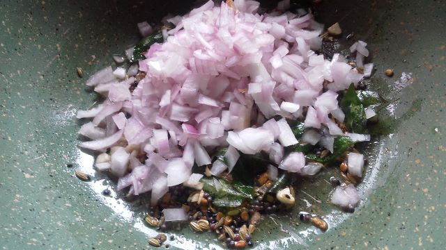 Saute onions for Achari Baingan