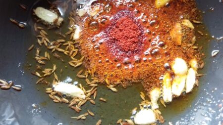 Mix in red chilli powder for lasooni moong dal tempering