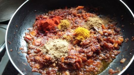 Add spices to the onion-tomato-gravy