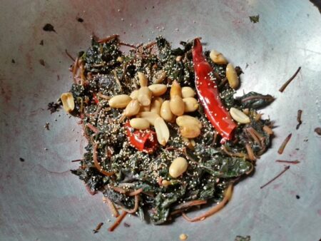 Add poppy seeds and peanuts to laal shaak fry