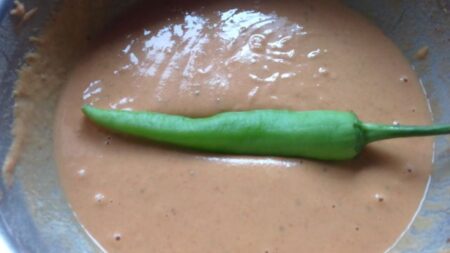 Dip green chillies in bhajji batter