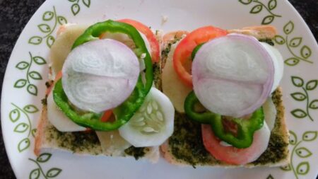 Place onionsslices over capsicum slices