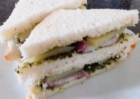 Cut Mumbai Green Chutney Sandwich into triangles