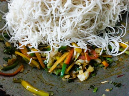 Add cooked noodles to veggies