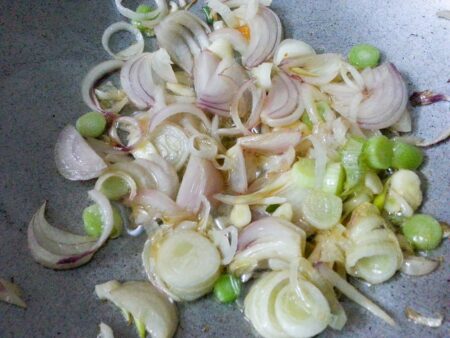 Add onions and spring onion to wok