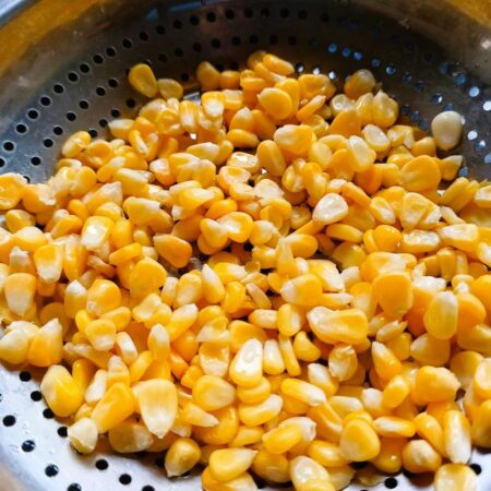 Drain corn in colander