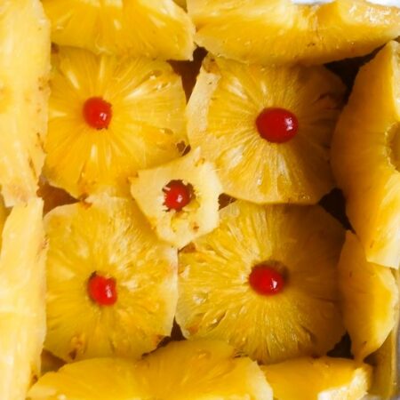 Halve pineapple slices and arrange around the pan for caramelized pineapple upside down cake