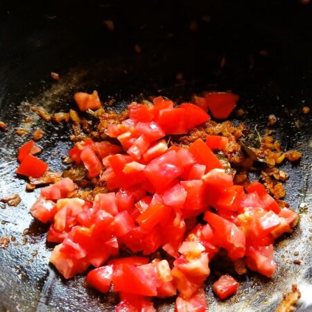Add tomatoes to the pan for liver curry