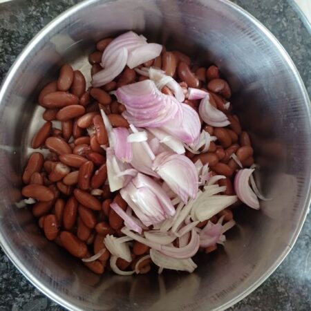 Add sliced onions to boiled rajmah
