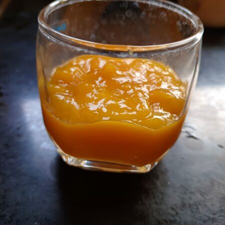 half-fill a glass with mango puree