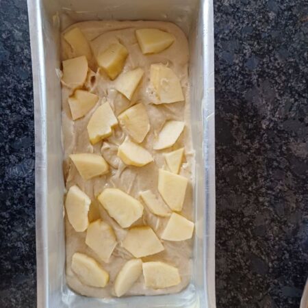 Place diced apples over batter