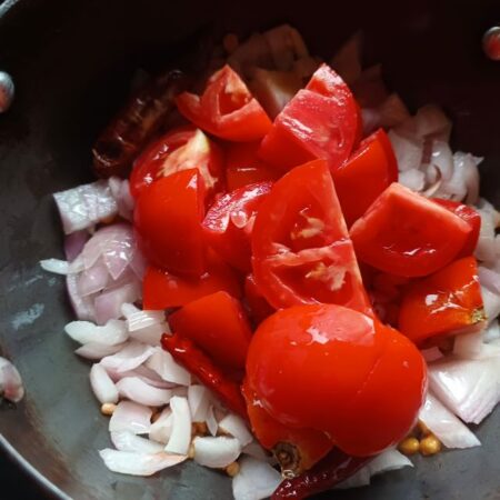 Add chopped tomatoes to the pan