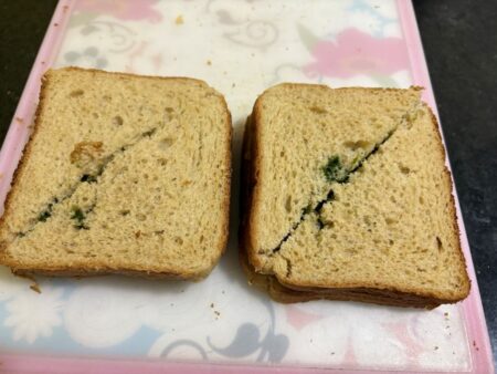 Cut the bread sandwich diagonally into two