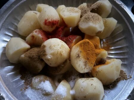 Add spices to boiled aloo for filling