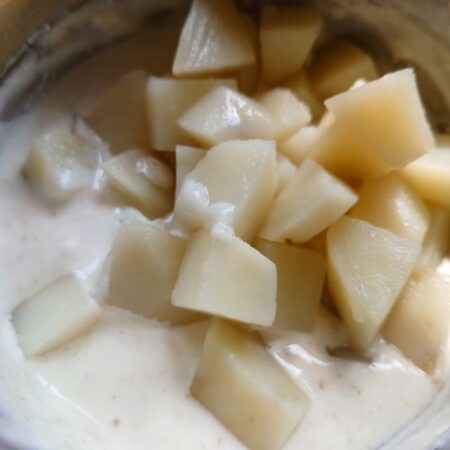 Add boiled potatoes to curd for Summer Salad