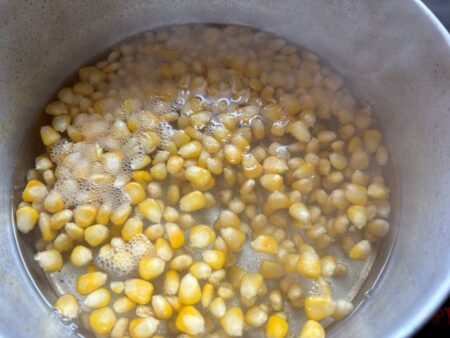 Boil Corn for colorful corn salad with bell peppers